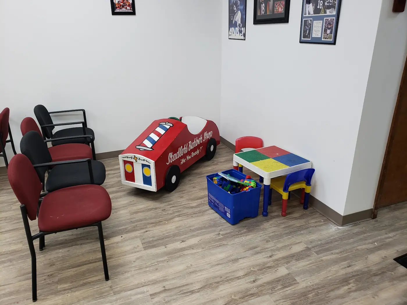 The red, white and blue wooden race-car kids' chair by the kids' corner at Stadler's